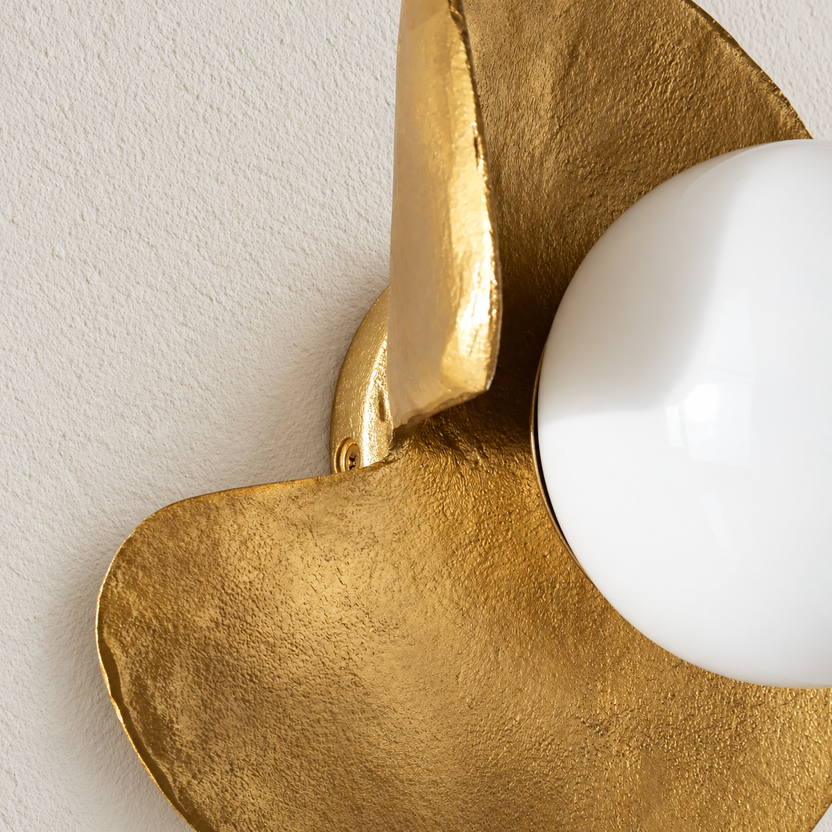 Close-up of the hammered copper surface and overlapping curved edges.