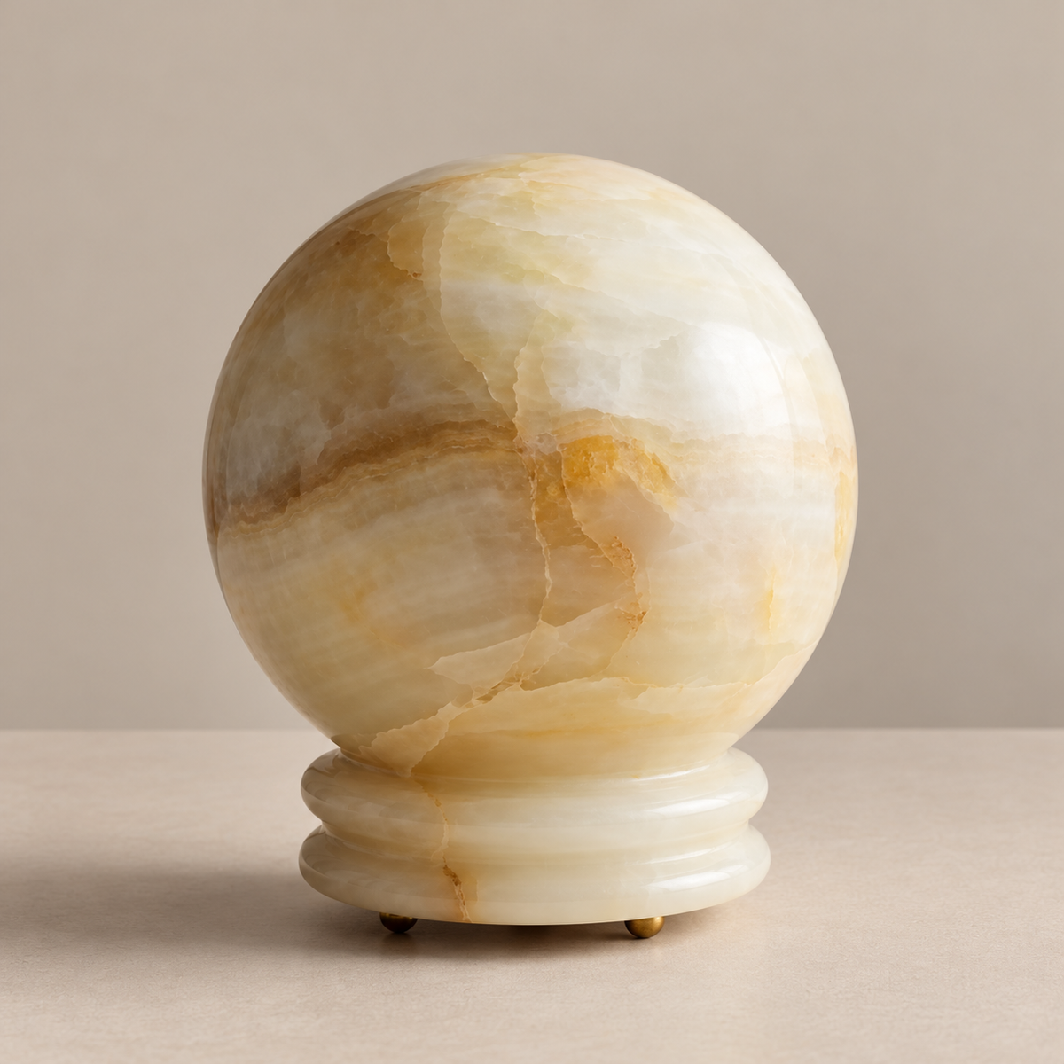 Onyx globe table lamp with a stepped stone base, unlit