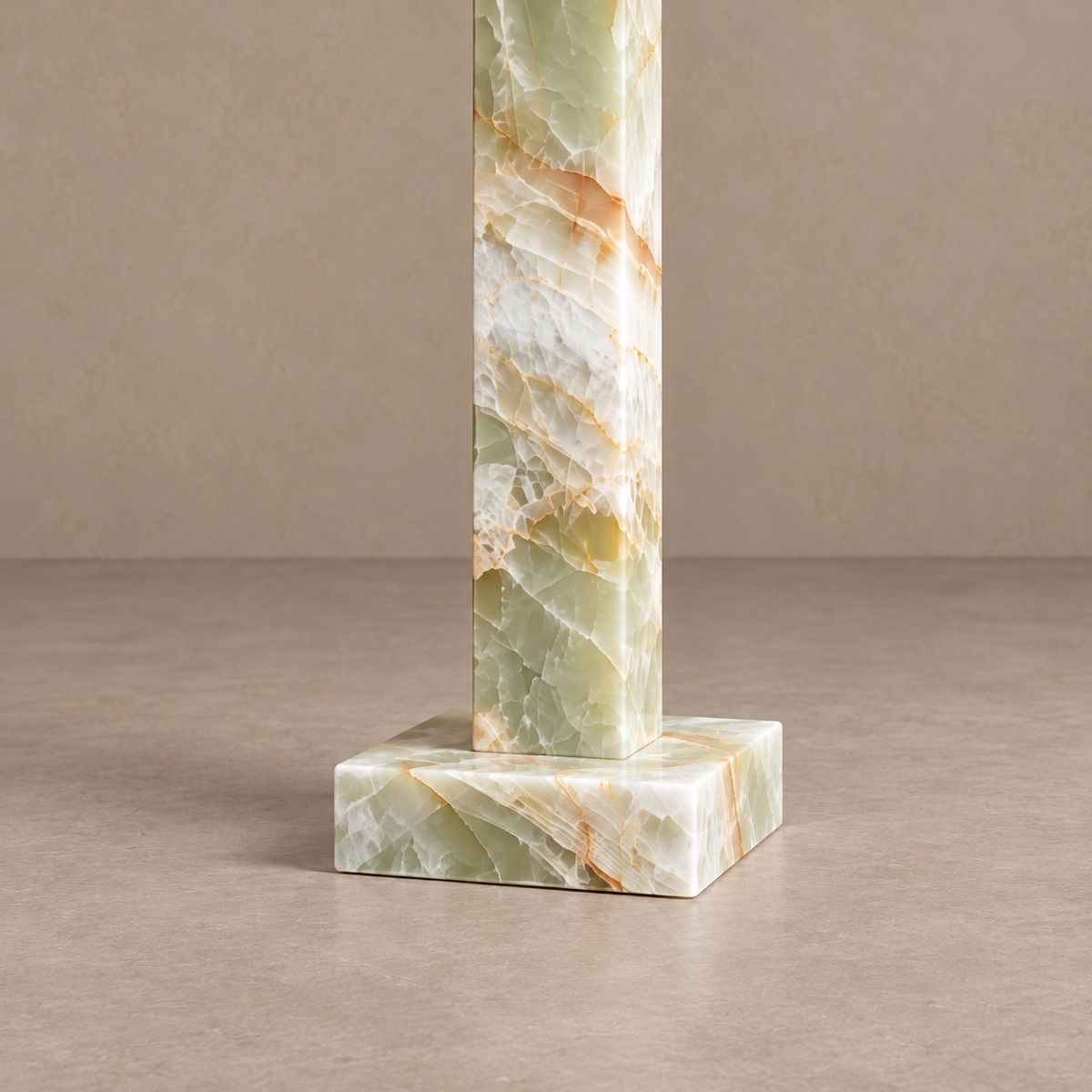 Detail of the green onyx column and shallow square stone base.