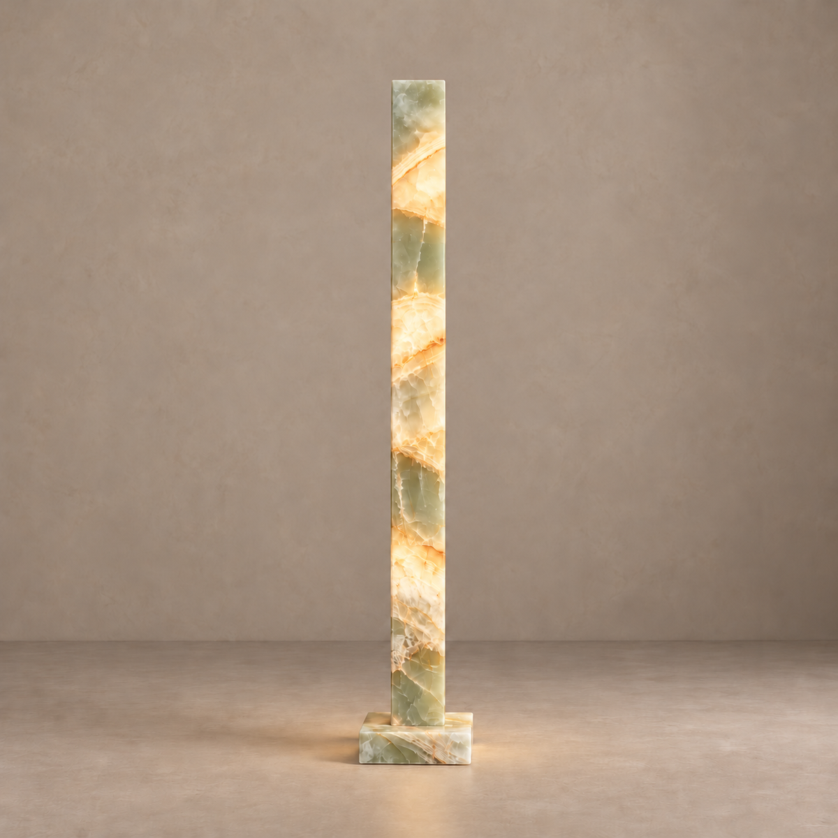 Large green onyx column lamp illuminated through its natural mineral layers.