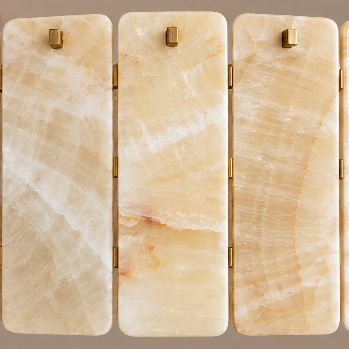 Close view of Matra Corona honey onyx panels and brass fixing studs.
