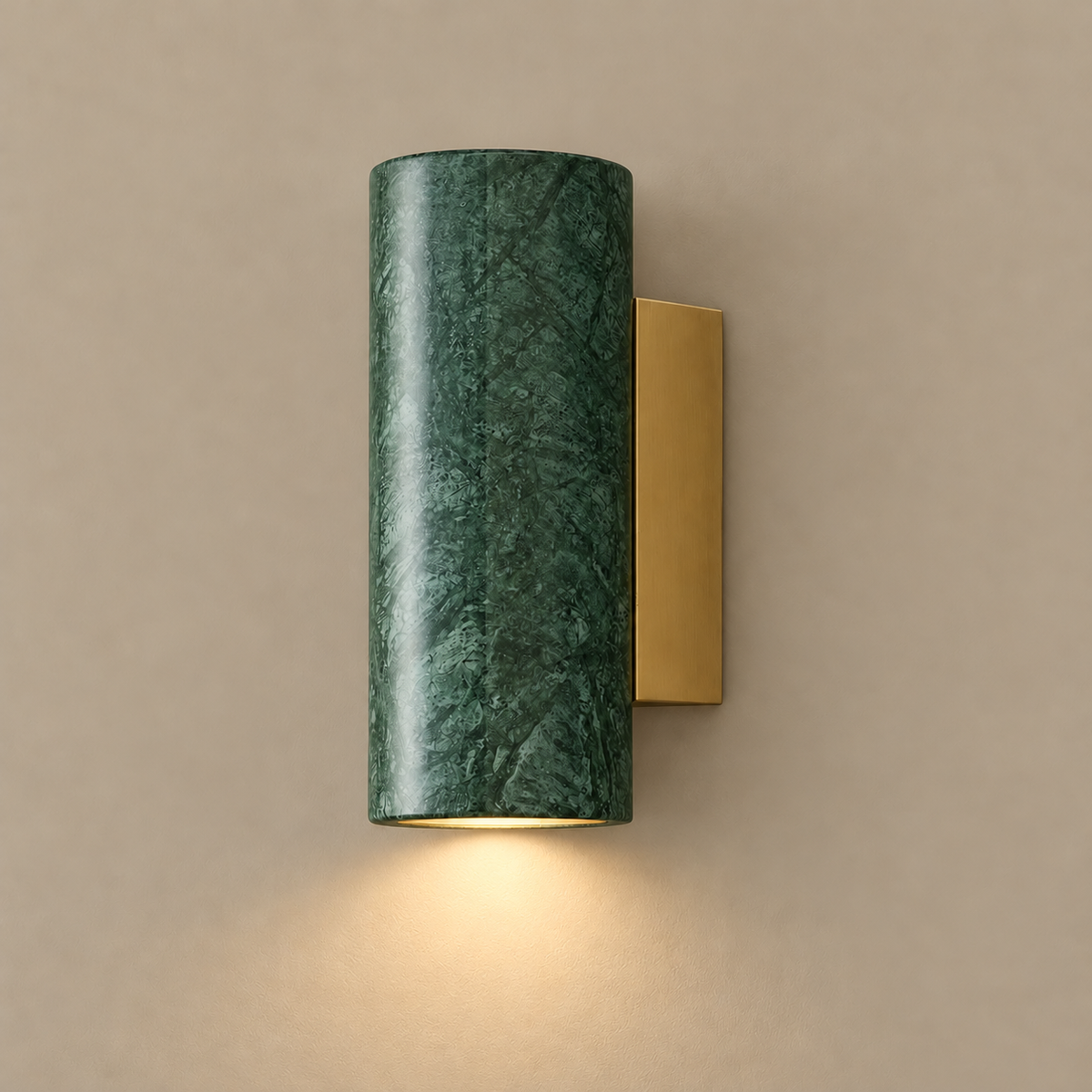 Marble block and brass wall sconce, illuminated on a stone-beige wall