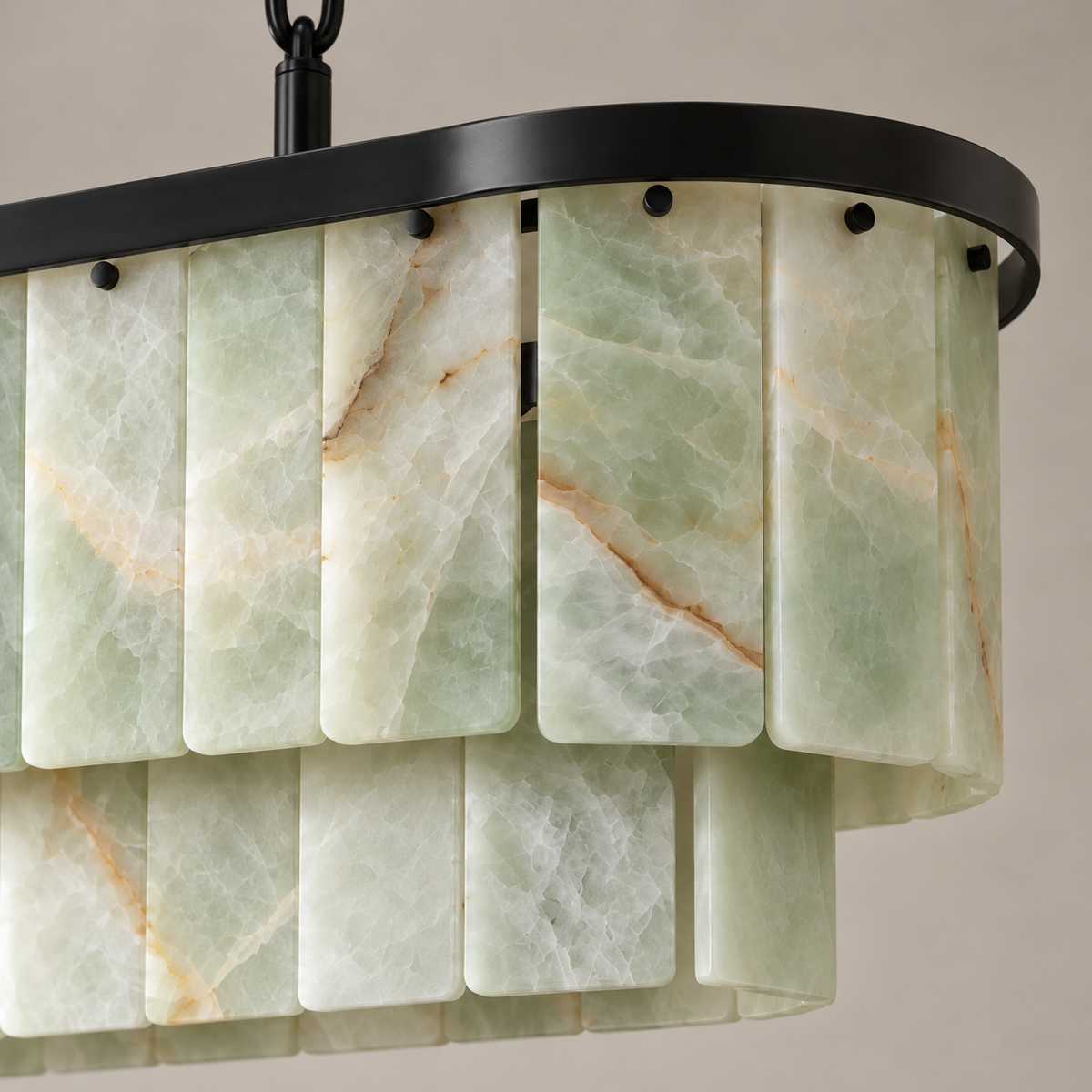 Green onyx panels and black fittings at the rounded end of the linear chandelier.