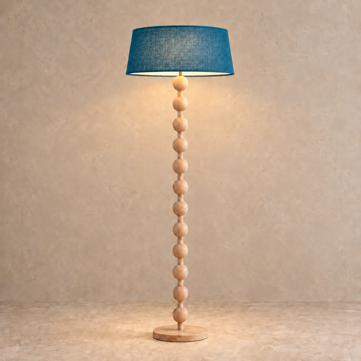 Sirmione Natural Wood Floor Lamp with petrol blue linen shade, illuminated in natural daylight.