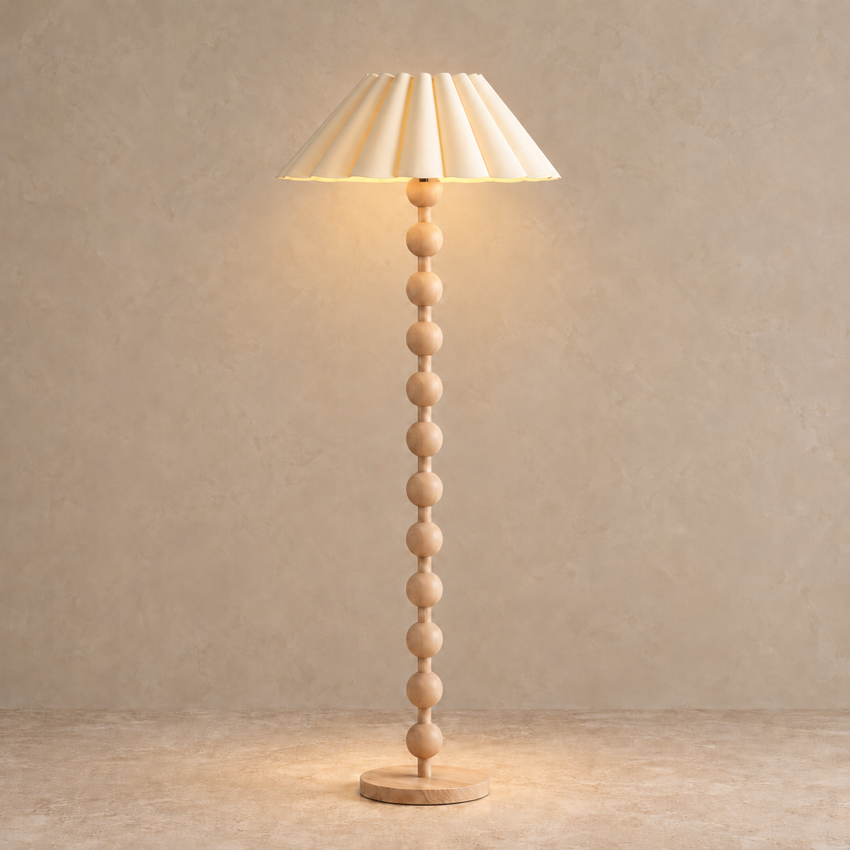 Sirmione Natural Wood Floor Lamp with cream sculptural pleated shade, illuminated in natural daylight.