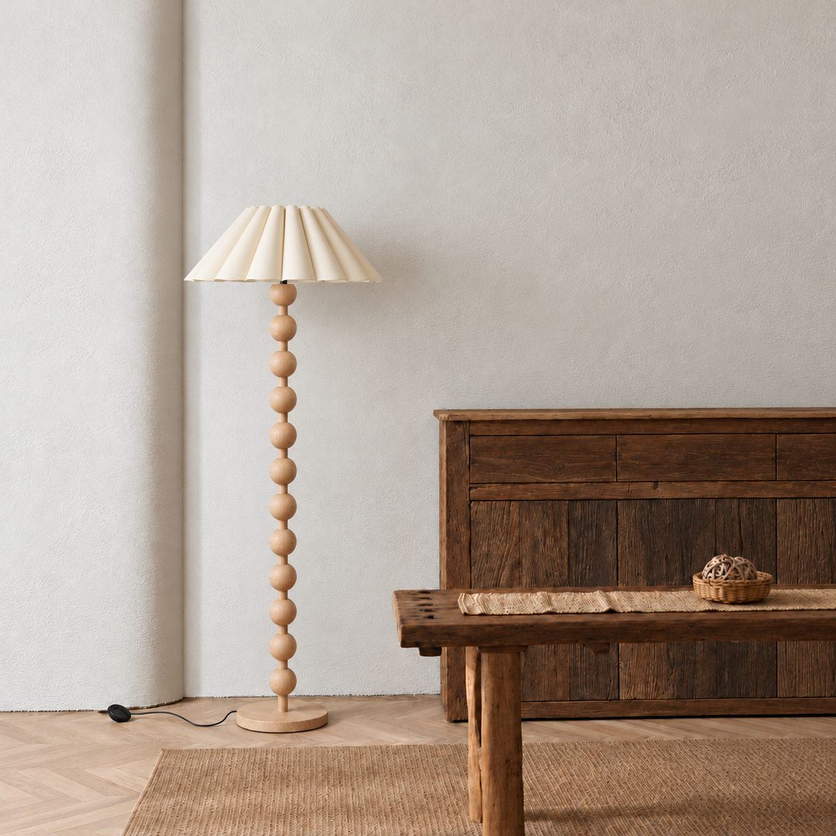 Sirmione Natural Wood Floor Lamp with cream sculptural pleated shade in a furnished room.