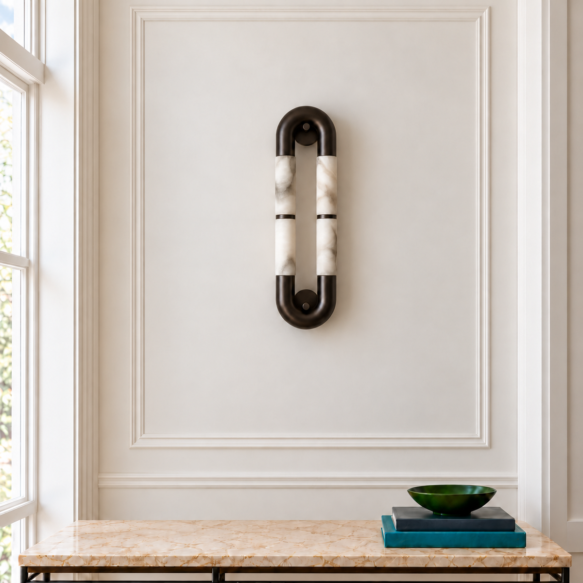 Alabaster and black metal loop wall sconce above a marble console in a Parisian entryway with ivory mouldings.