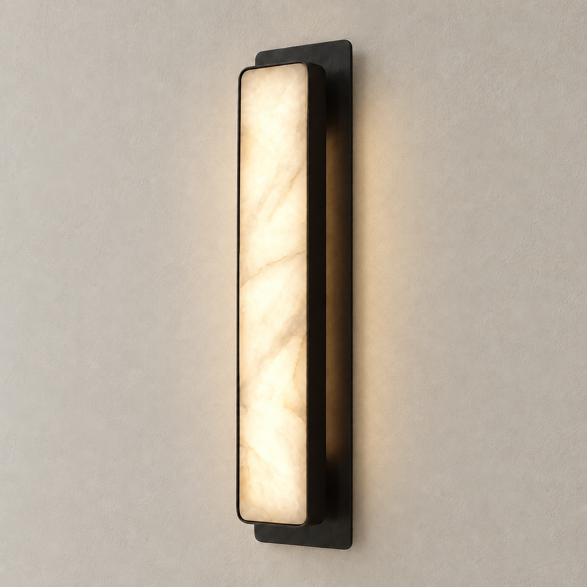 Black Mont alabaster wall sconce illuminated on the same beige wall.