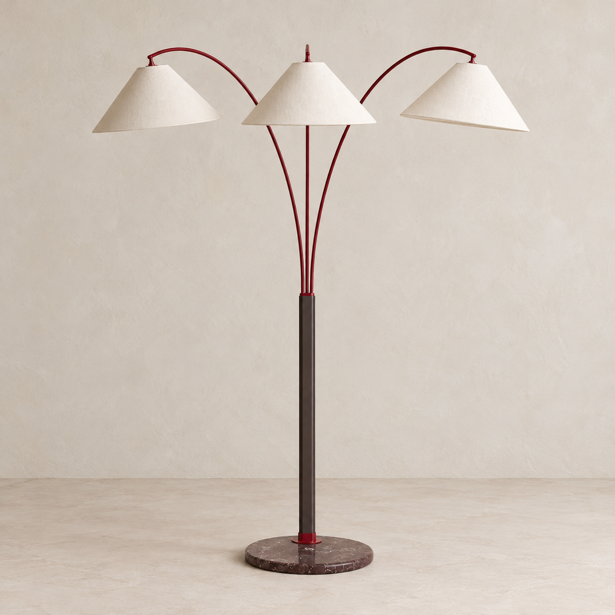 Triple-arm floor lamp with burgundy arms, ivory linen shades and a brown marble base, switched off.
