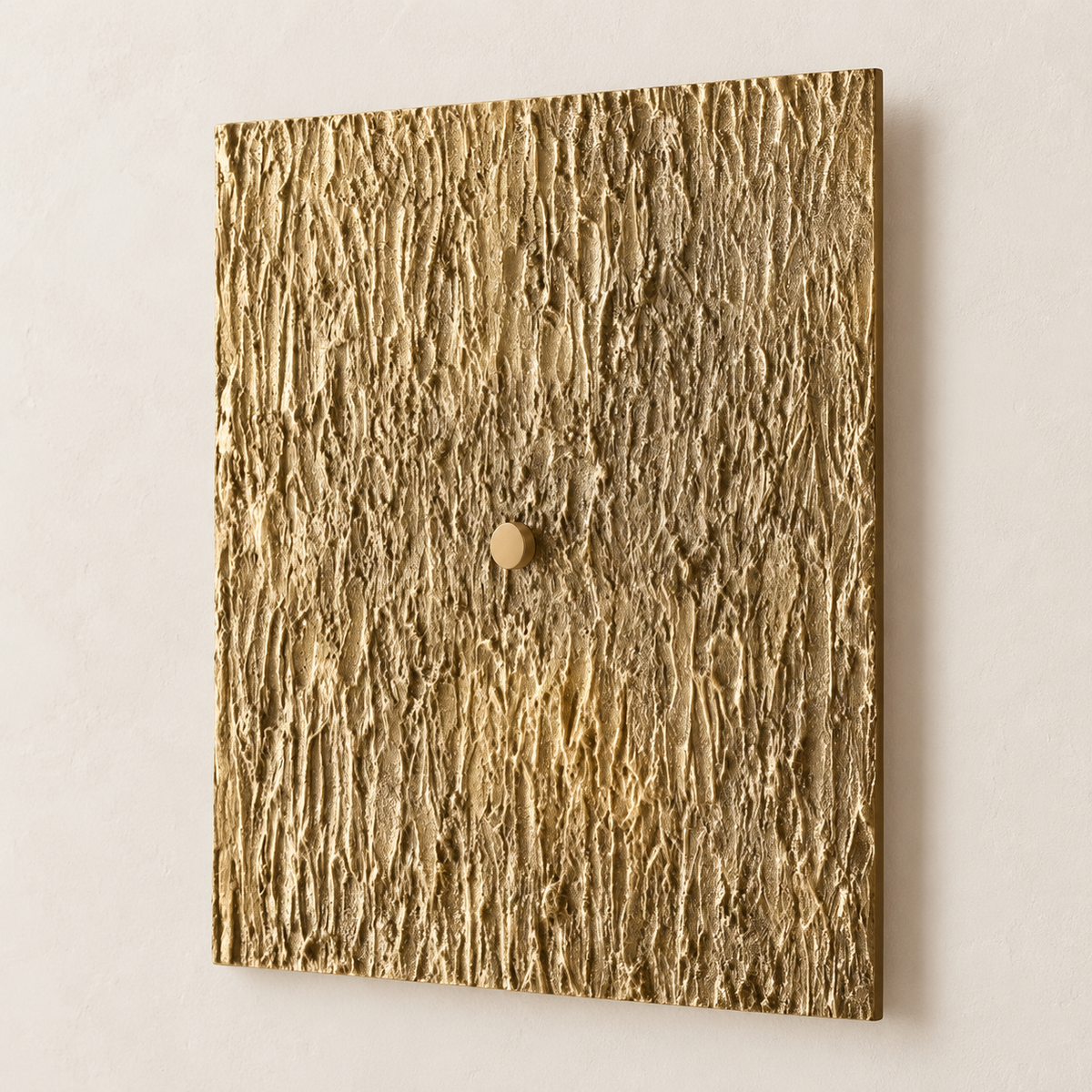 Gold-toned Ratera square wall sconce with a deeply textured surface, viewed at an angle.