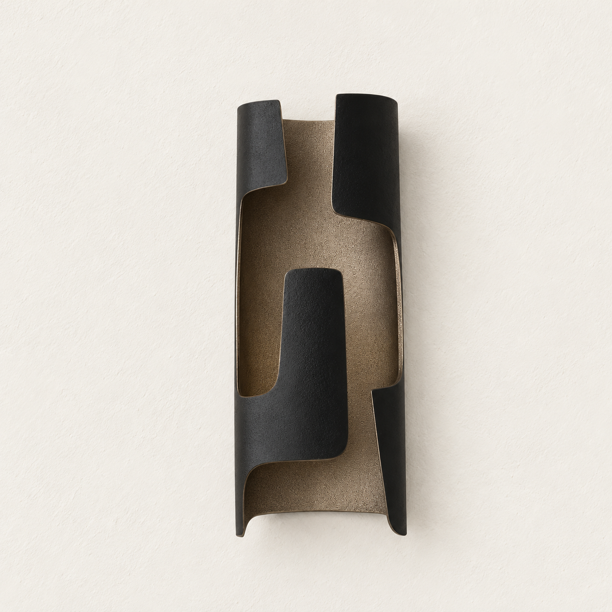 Slender dark patinated bronze folded sconce unlit against warm ivory plaster.