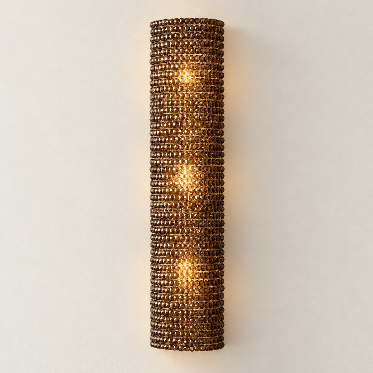 90 cm amber crystal sconce illuminated in the same ivory setting.