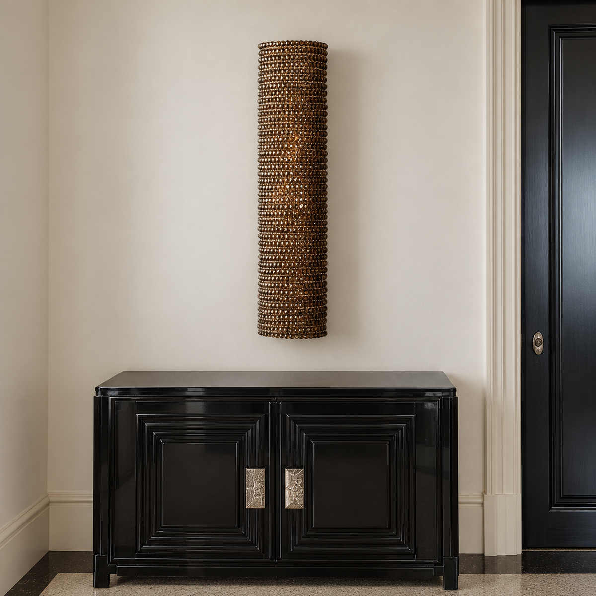 90 cm amber crystal wall sconce above a black cabinet in an ivory entryway.