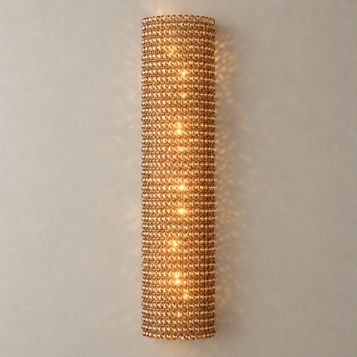 90 cm amber crystal wall sconce illuminated, showing light through the faceted beads.