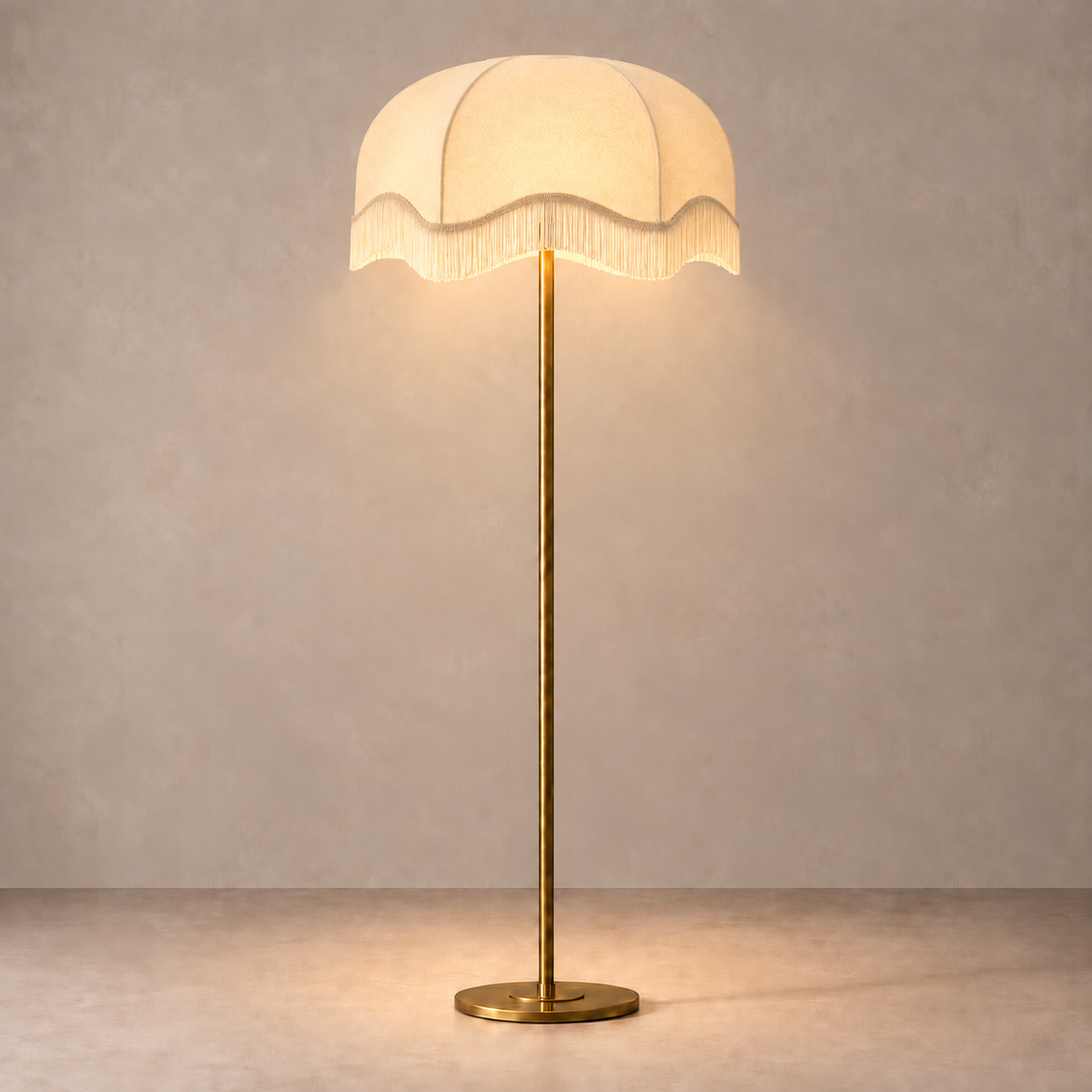 Brushed Brass Floor Lamp with cream scalloped fringe shade, illuminated in natural daylight.