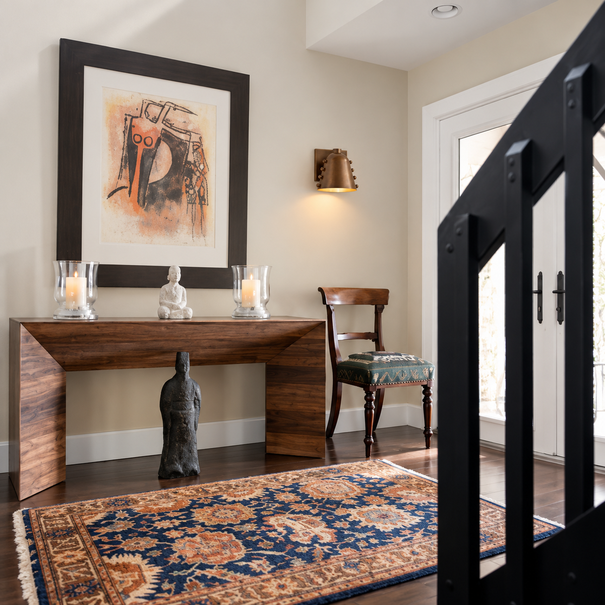 Small brass cone sconce installed beside entryway artwork.