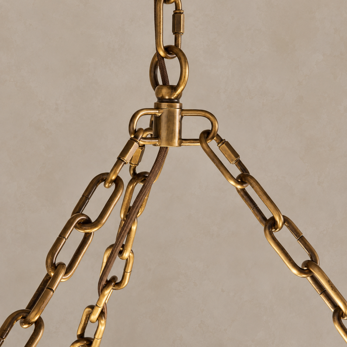 Brass chain links and three-way suspension junction with the braided electrical cord.
