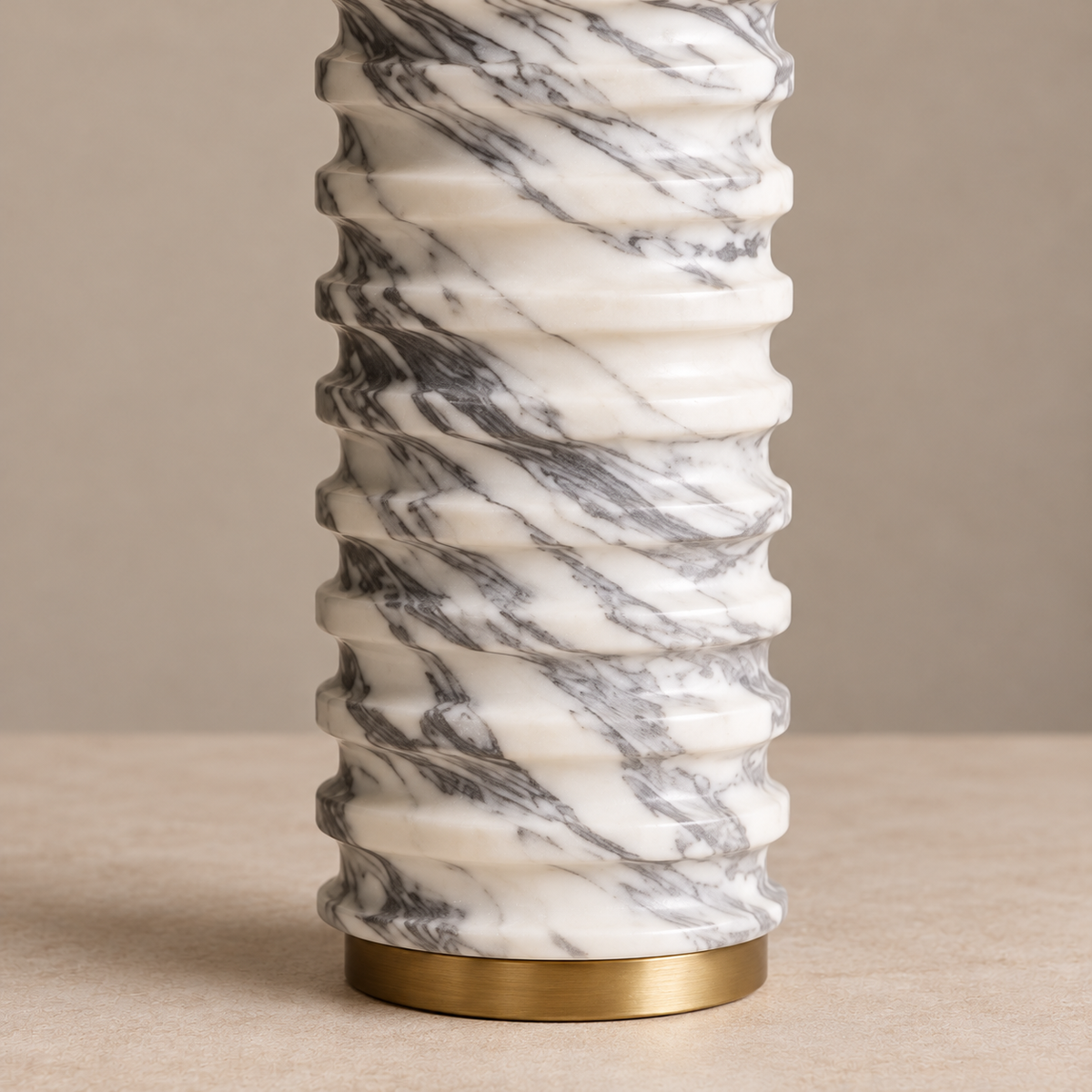 Detail of the carved marble ribs, grey veins and brass foot