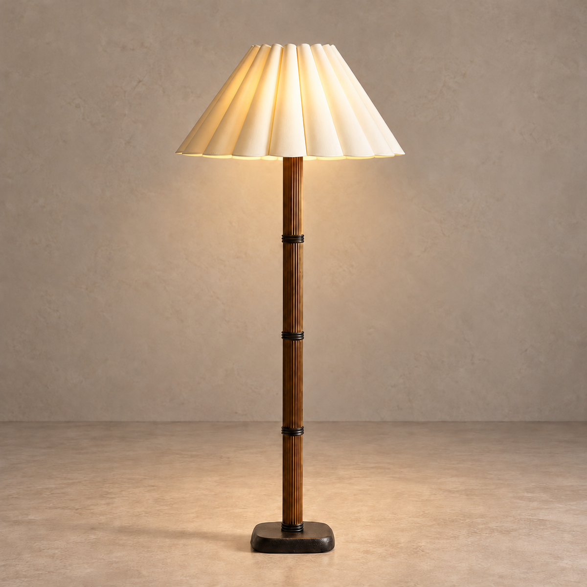 Galerie fluted column floor lamp with its broad cream sculptural pleated shade illuminated.