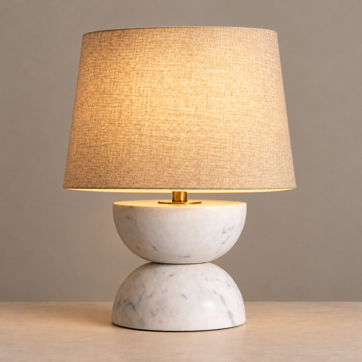 Zana marble table lamp with linen shade illuminated