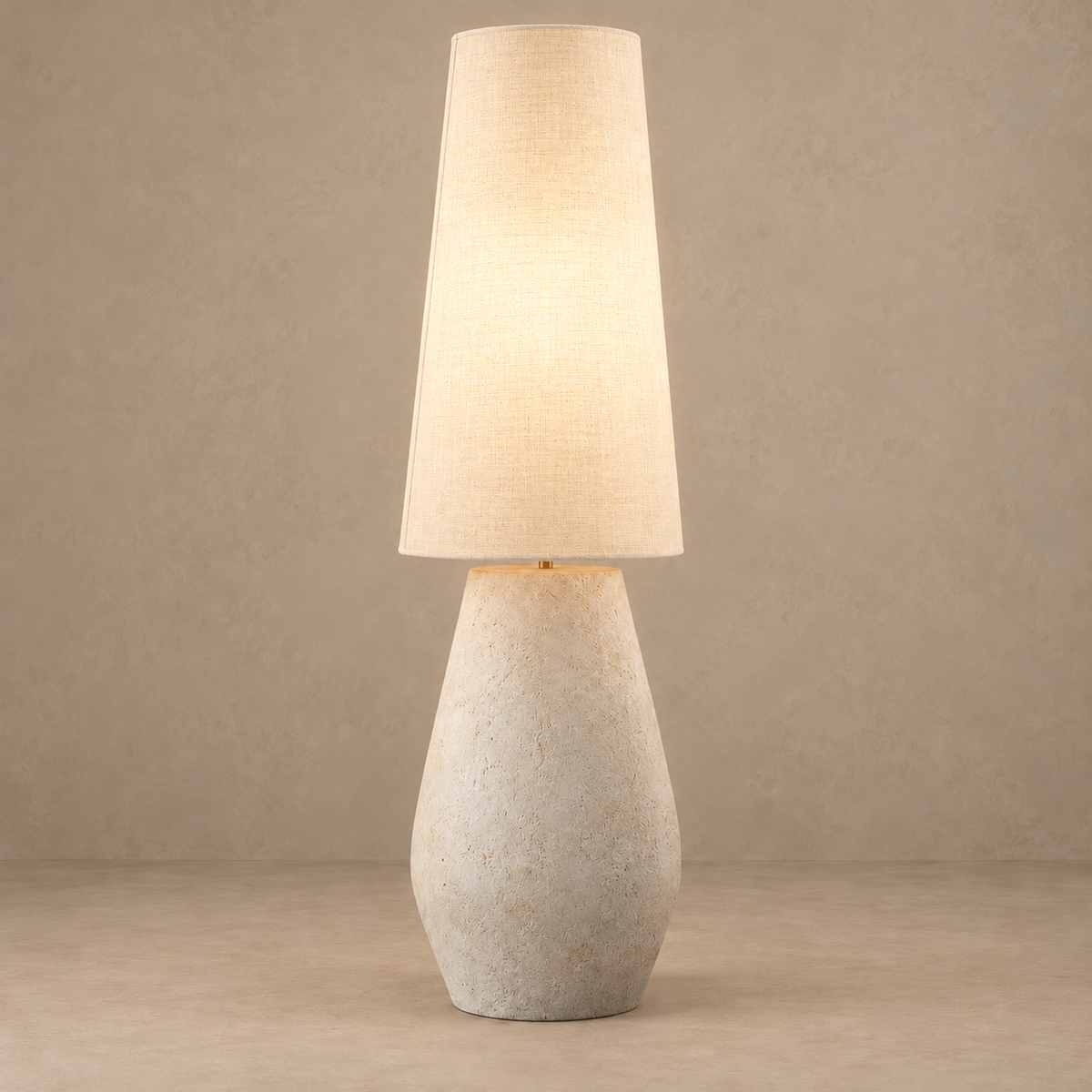 Como floor lamp illuminated, with light diffusing through its ivory linen shade