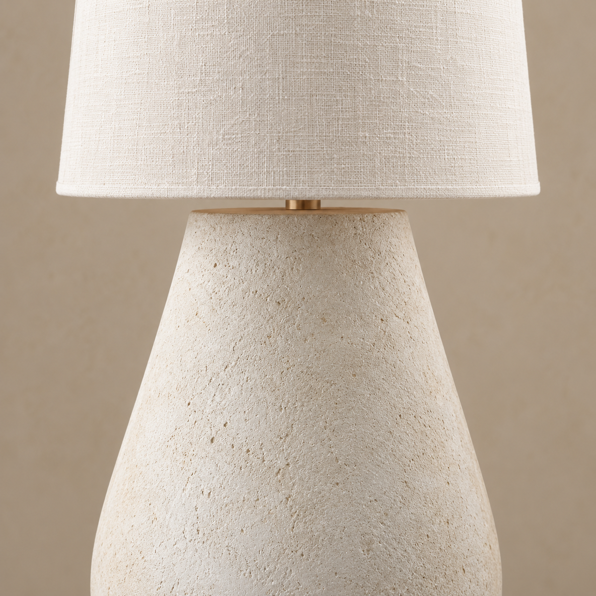 Close view of Como’s linen shade edge, small metal connector and textured plaster vessel