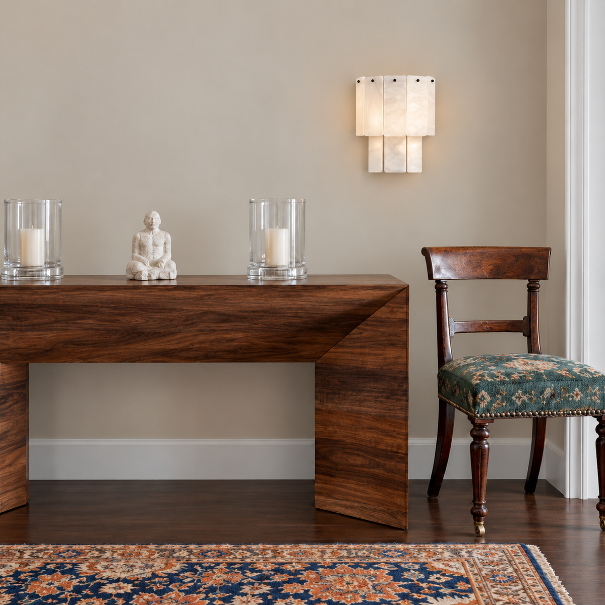Layered alabaster sconce installed above a walnut entryway console.