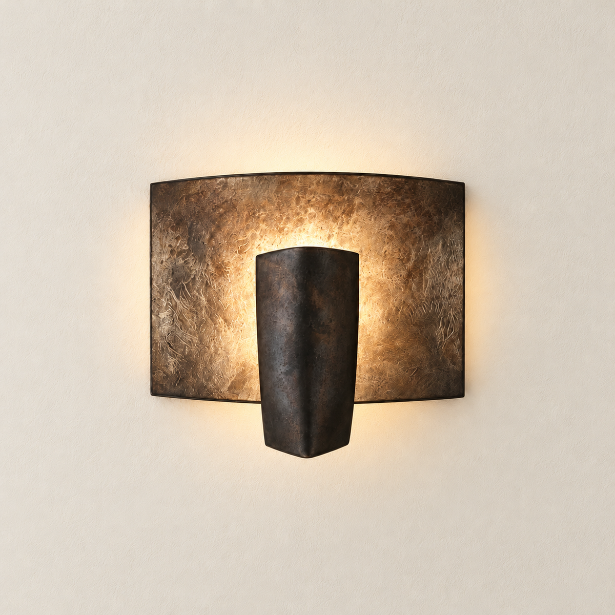 Kyrin aluminium sconce illuminated behind its projecting central shield.