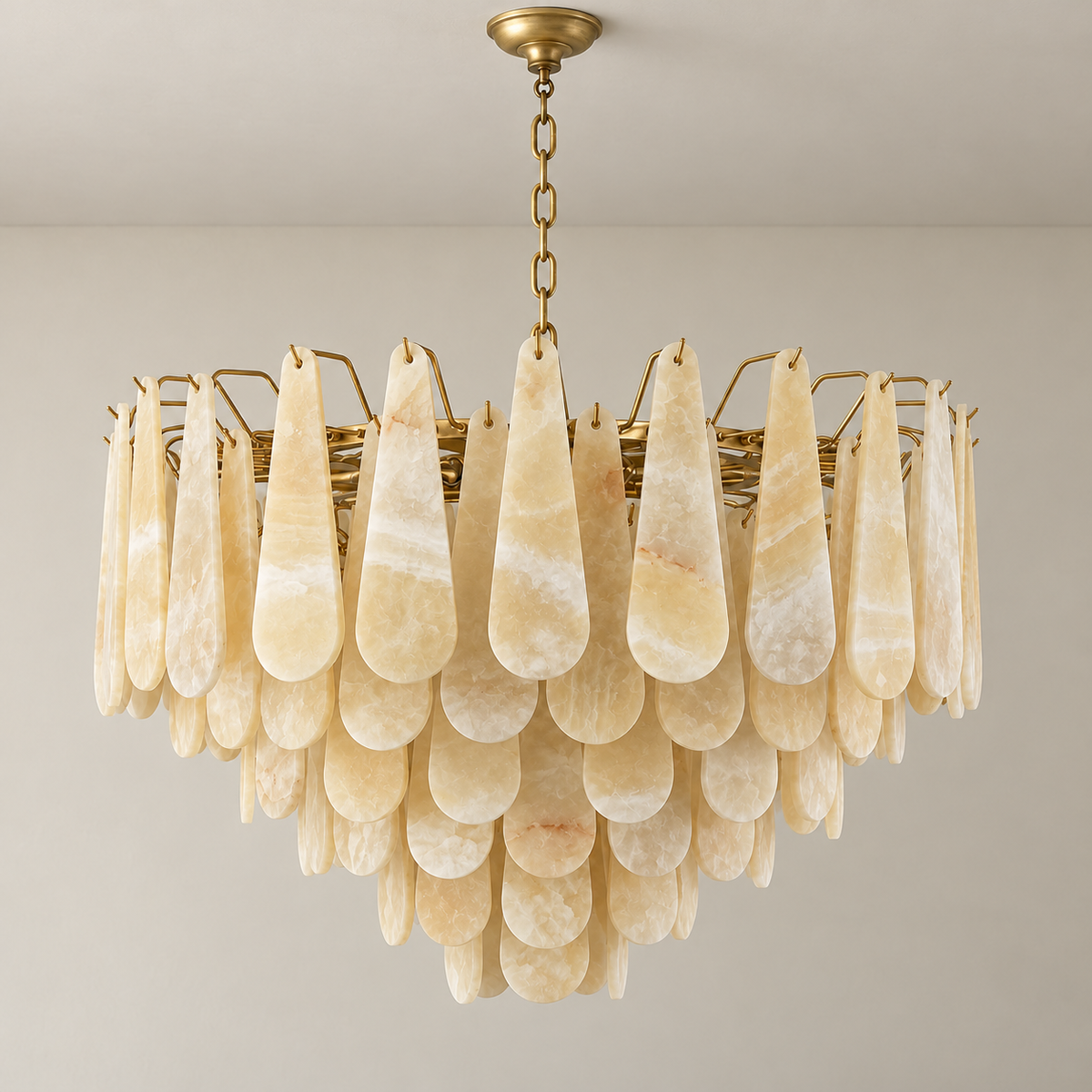 80 cm Goccia honey onyx chandelier with six tiers and brass suspension, switched off.