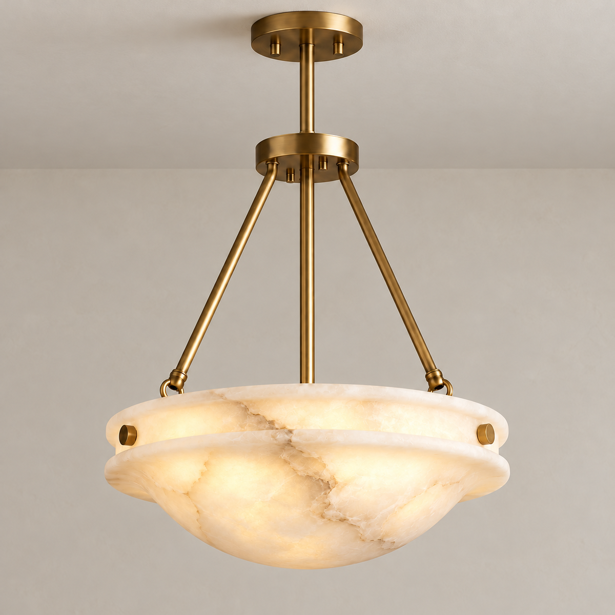 Grande Alba alabaster bowl ceiling light with brass supports, illuminated.