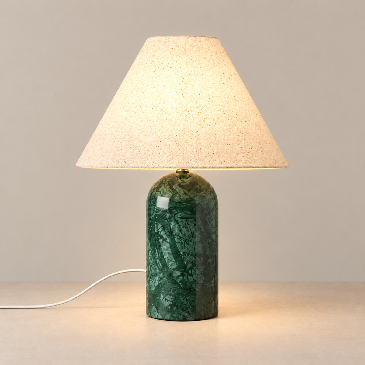 Green Marble Table Lamp, illuminated, on a beige background.