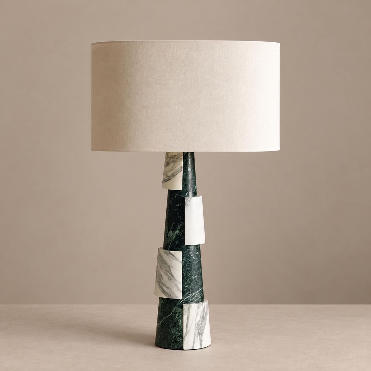 Green and white marble table lamp with linen drum shade, switched off.