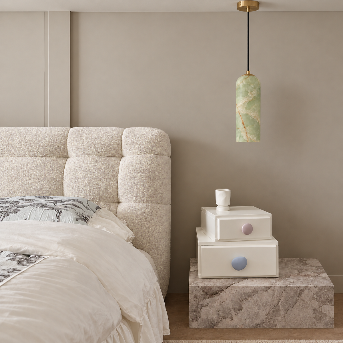 Green Onyx Column Pendant with Brass above a stone bedside table, shown in natural daylight.