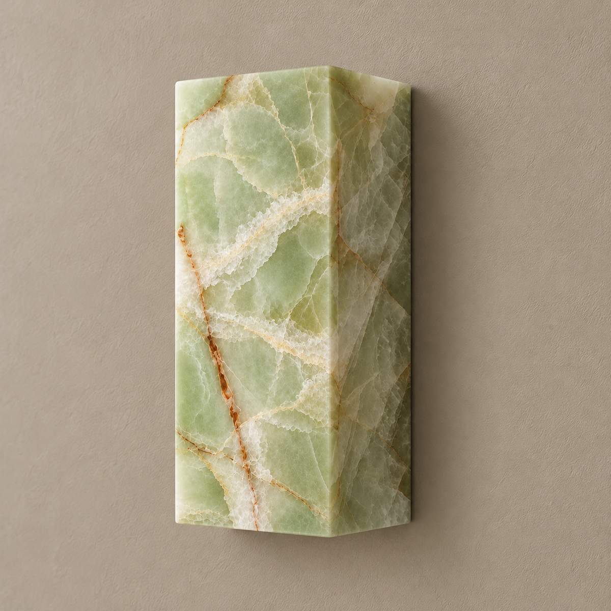 Green onyx column wall lamp in a three-quarter view showing its deep stone body and natural cream mineral bands.