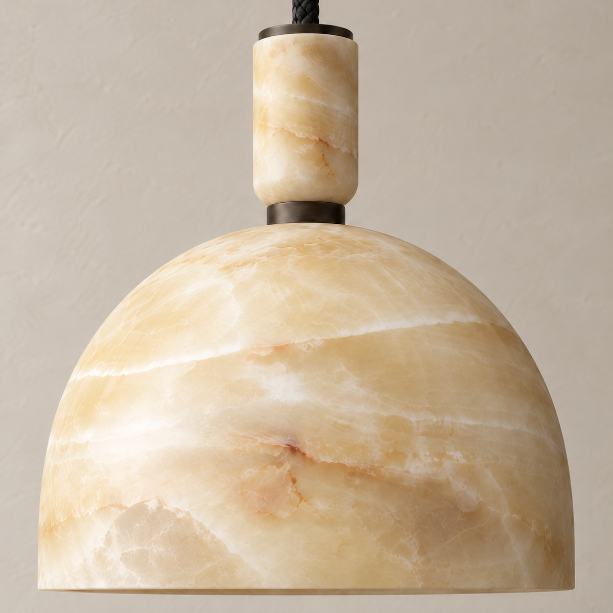 Close-up of the honey onyx dome, stone collar and dark metal connector.