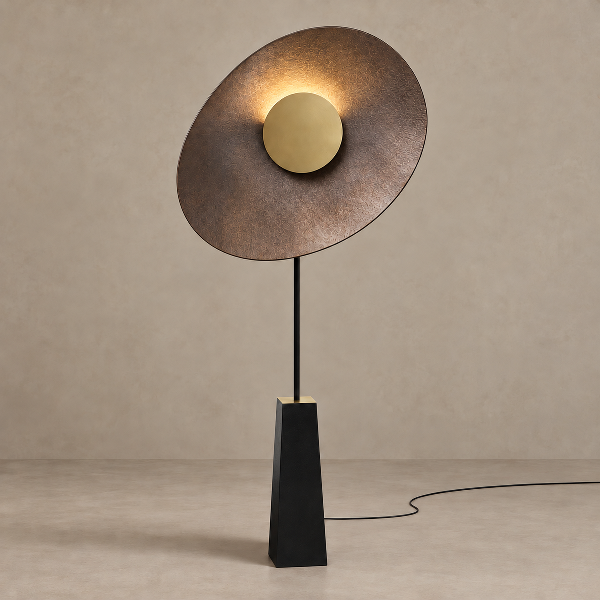 Island floor lamp illuminated behind its central brass cap against a stone-beige background.