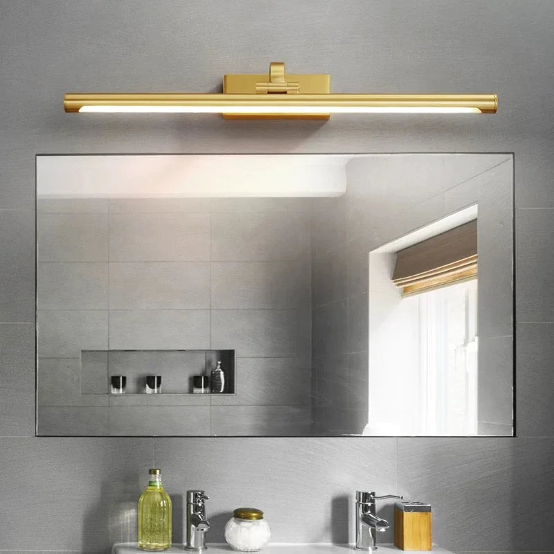 Brass LED bar mounted above a bathroom mirror