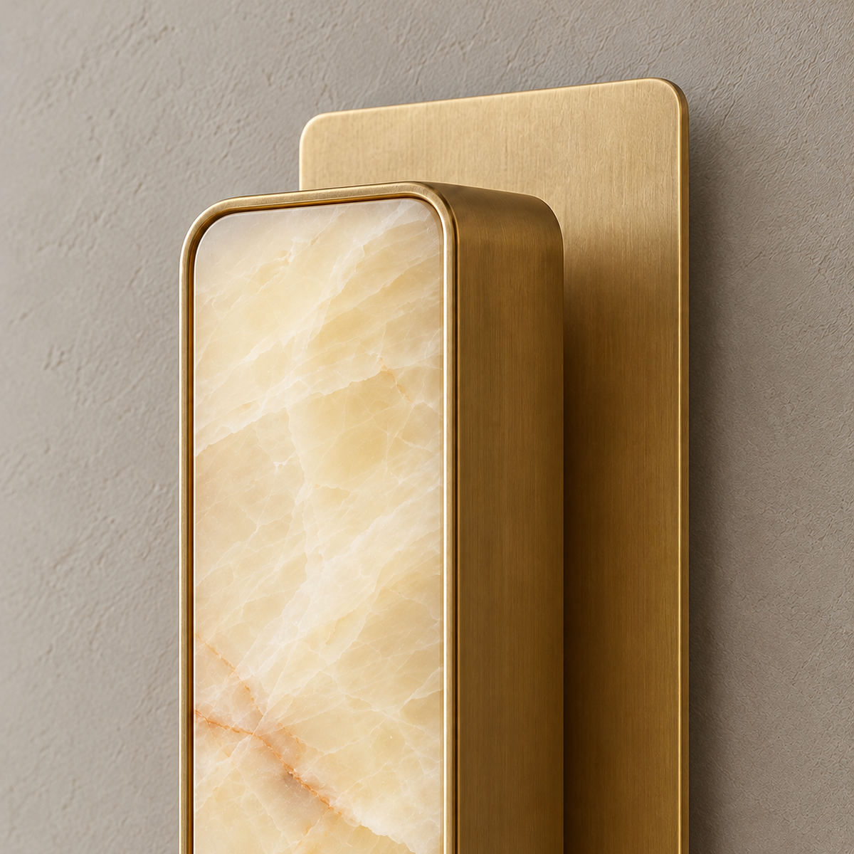 Close-up of Mont's raised honey onyx diffuser, brass housing and separate wall plate.