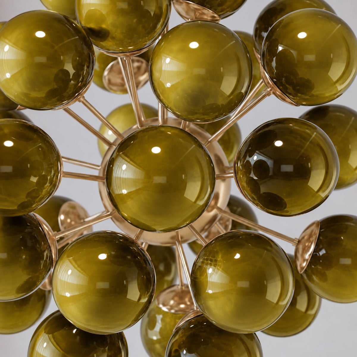 Detail of the hand-blown olive green glass globes and brass arms, De Silva chandelier CLPT80CH-OL
