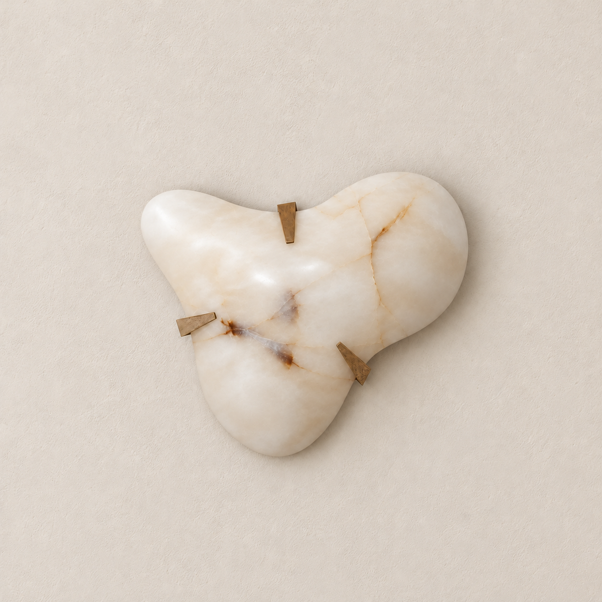 Additional front view of the asymmetric alabaster cloud sconce and its three brass clips.