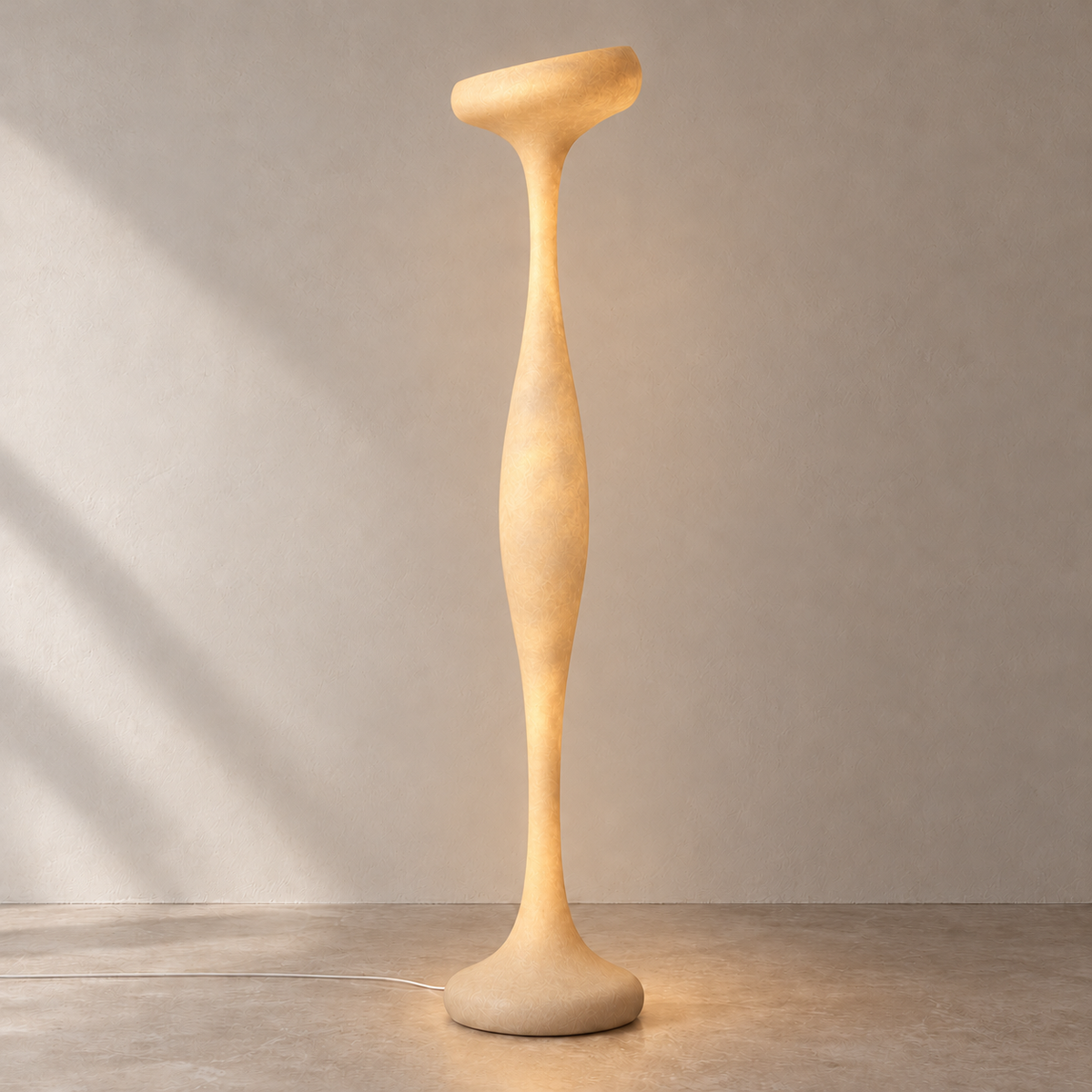 Ostia resin floor lamp glowing softly through its sculptural body on the same beige background.