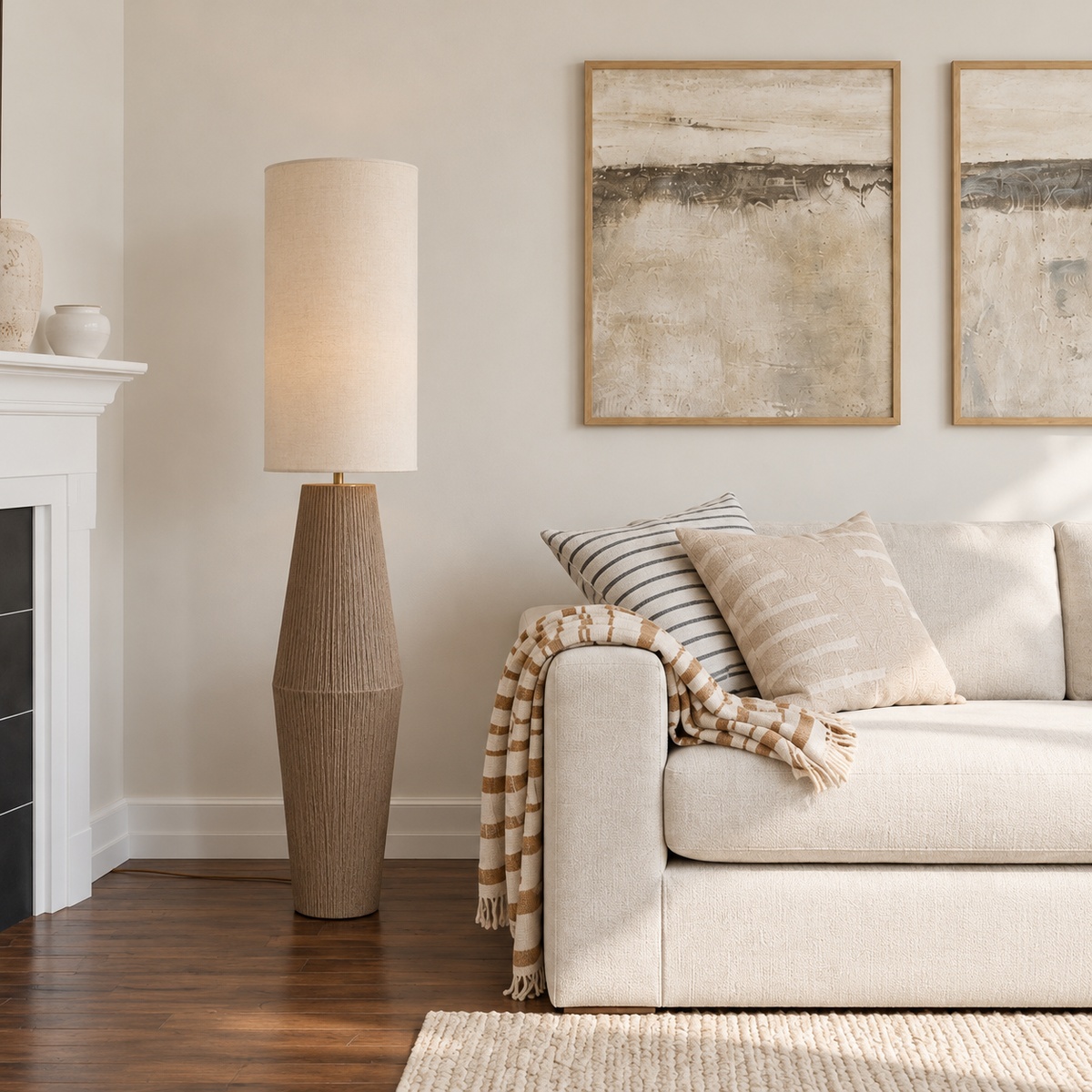 Palestrina floor lamp beside a cream sofa in a daylight living room with framed abstract art.