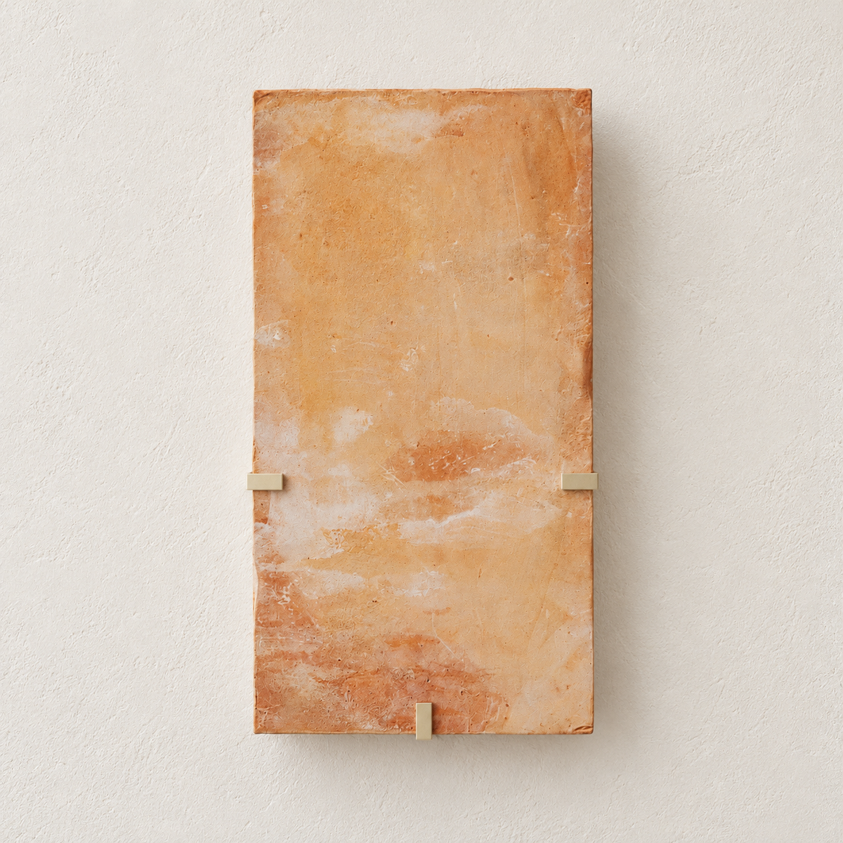 Unlit Parefeuille Petite orange onyx wall sconce with three brass retaining clips on warm ivory.