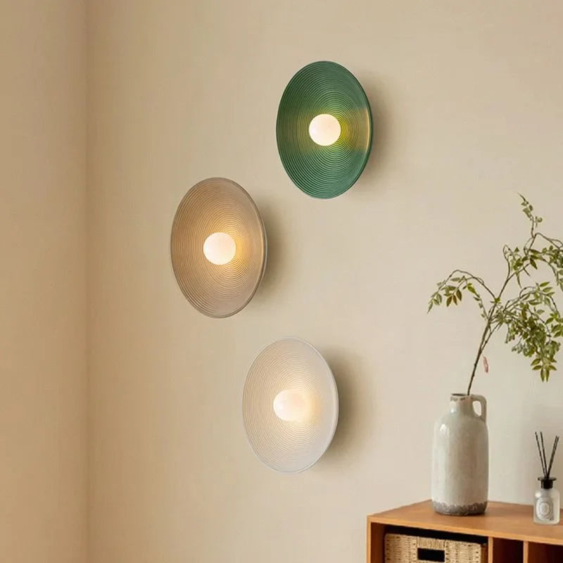 Round iron wall light in a bedroom