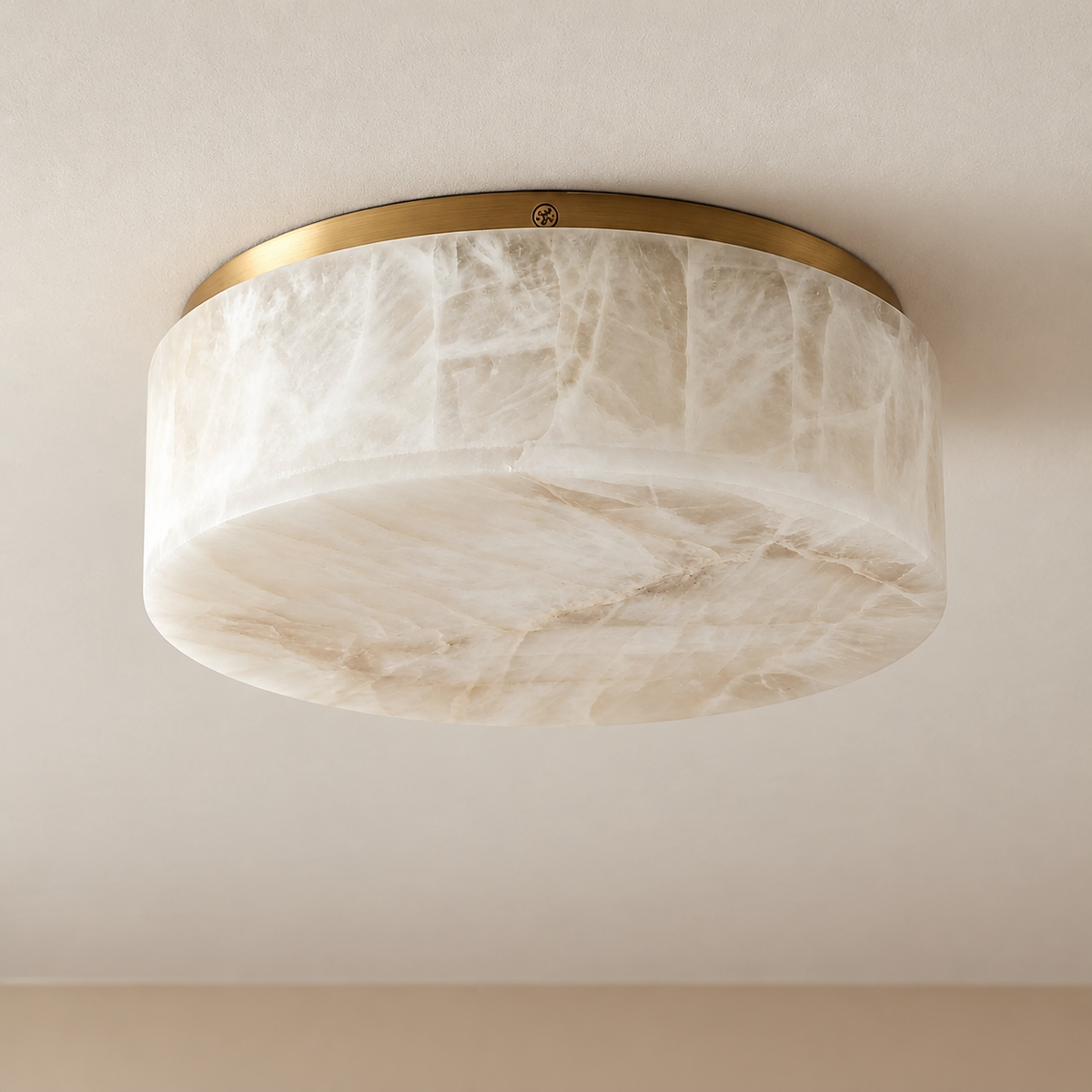 Round alabaster flush mount with brass rim, unlit, showing natural layered stone.