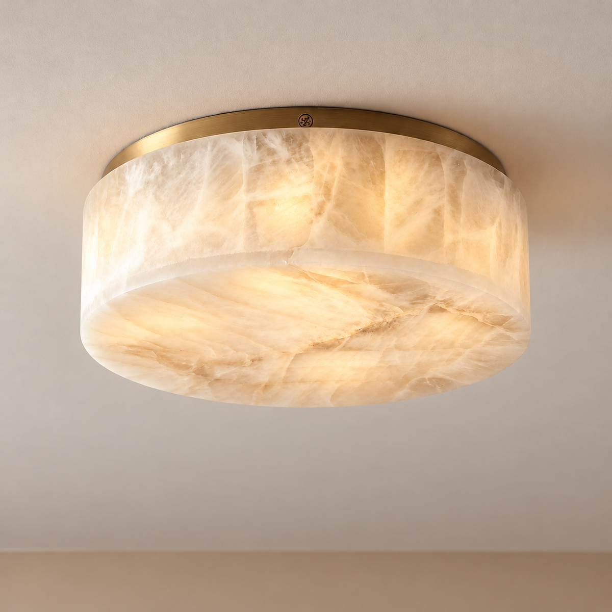 Brass-rimmed round alabaster flush mount lit, with its mineral layers visible.