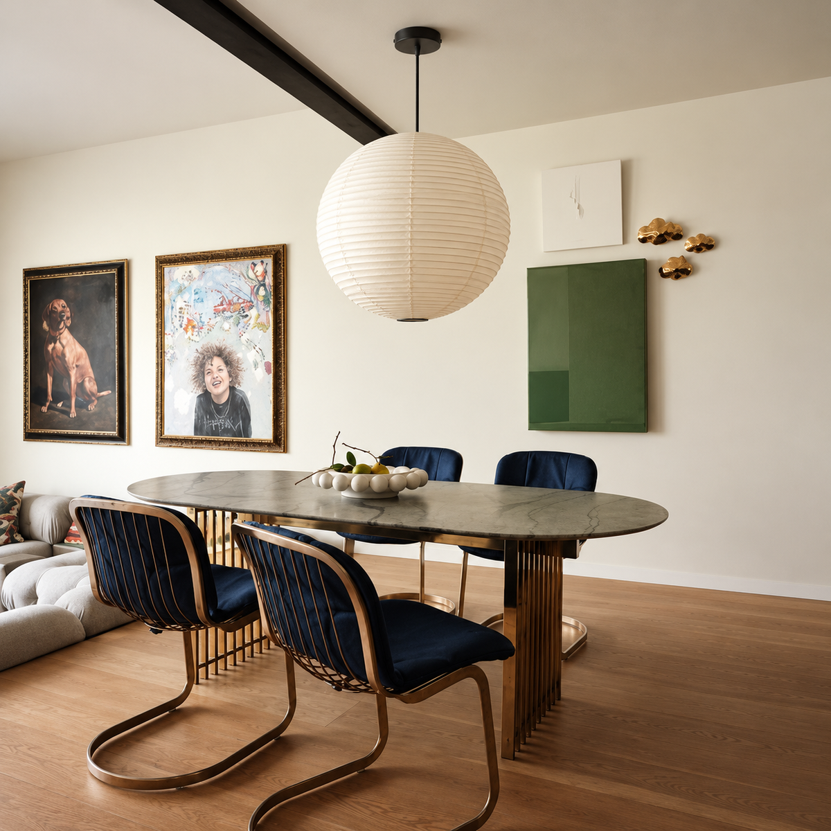 Round paper lantern suspended over an oval marble dining table
