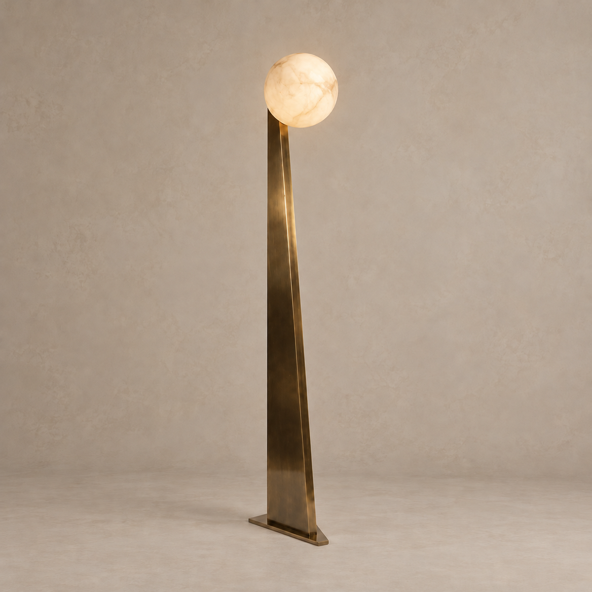 Alabaster globe illuminated above the solid tapered brass support.