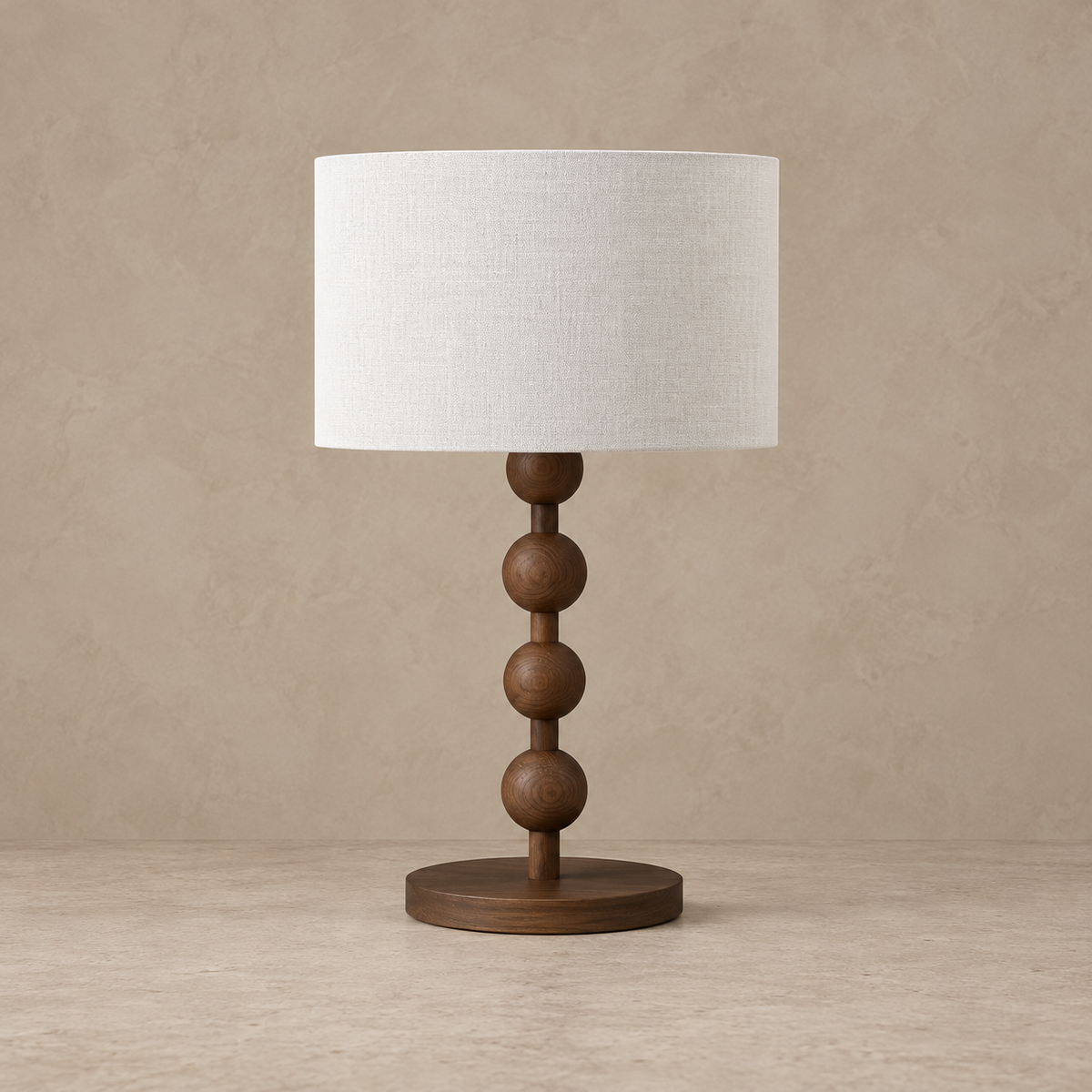 Sirmione walnut table lamp with four wooden beads and a white linen drum shade, switched off.