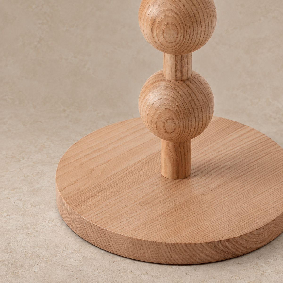 Close view of Sirmione's natural wood beads, dowel joints and circular base.